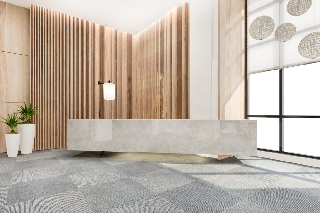 Modern commercial lobby with large-format rectified porcelain floor tiles, narrow grout joints, and contemporary architectural design.