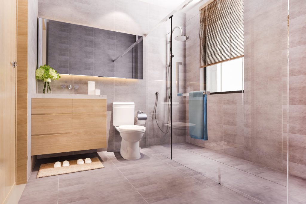 Modern bathroom with tiled floor and wall surfaces, walk-in shower and floating vanity in neutral tones.