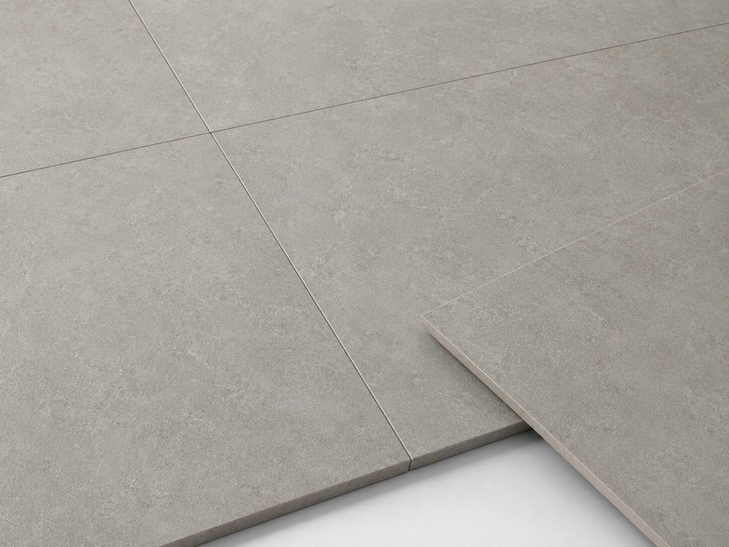 Large-format rectified porcelain tiles featuring precision-cut edges and minimal grout lines for a seamless modern appearance.