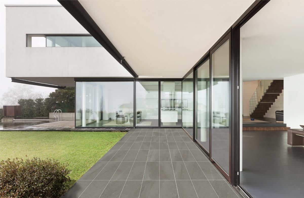 A Kimgres tiled surface running seamlessly from an indoor living space out to a patio